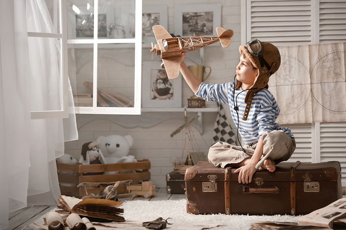 boy-playing-wooden-plane-pilot-gear1200